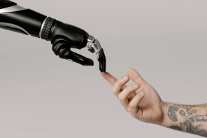 Someone touching a robot’s finger with his own.